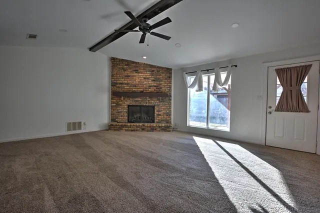 a view of an empty room with a fireplace