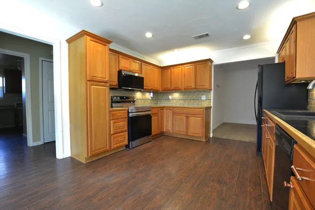 a kitchen with stainless steel appliances granite countertop a sink and cabinets