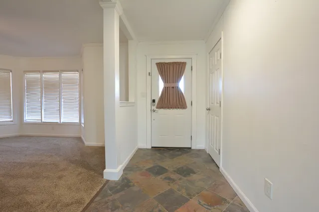 a view of an empty room with a window