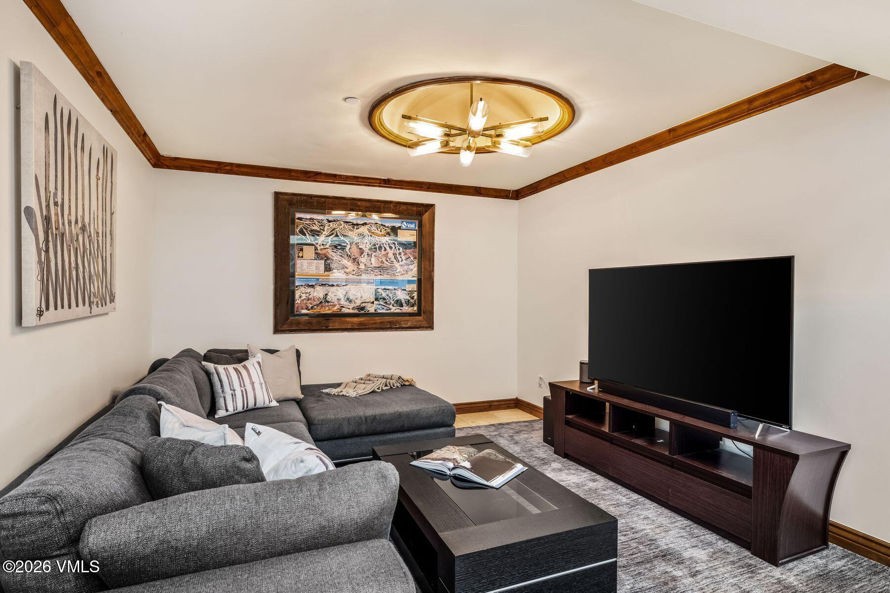 12 Vail Road, Unit R8 Vail, CO 81657 - Photo 13 of 41 a living room with furniture and a flat screen tv
