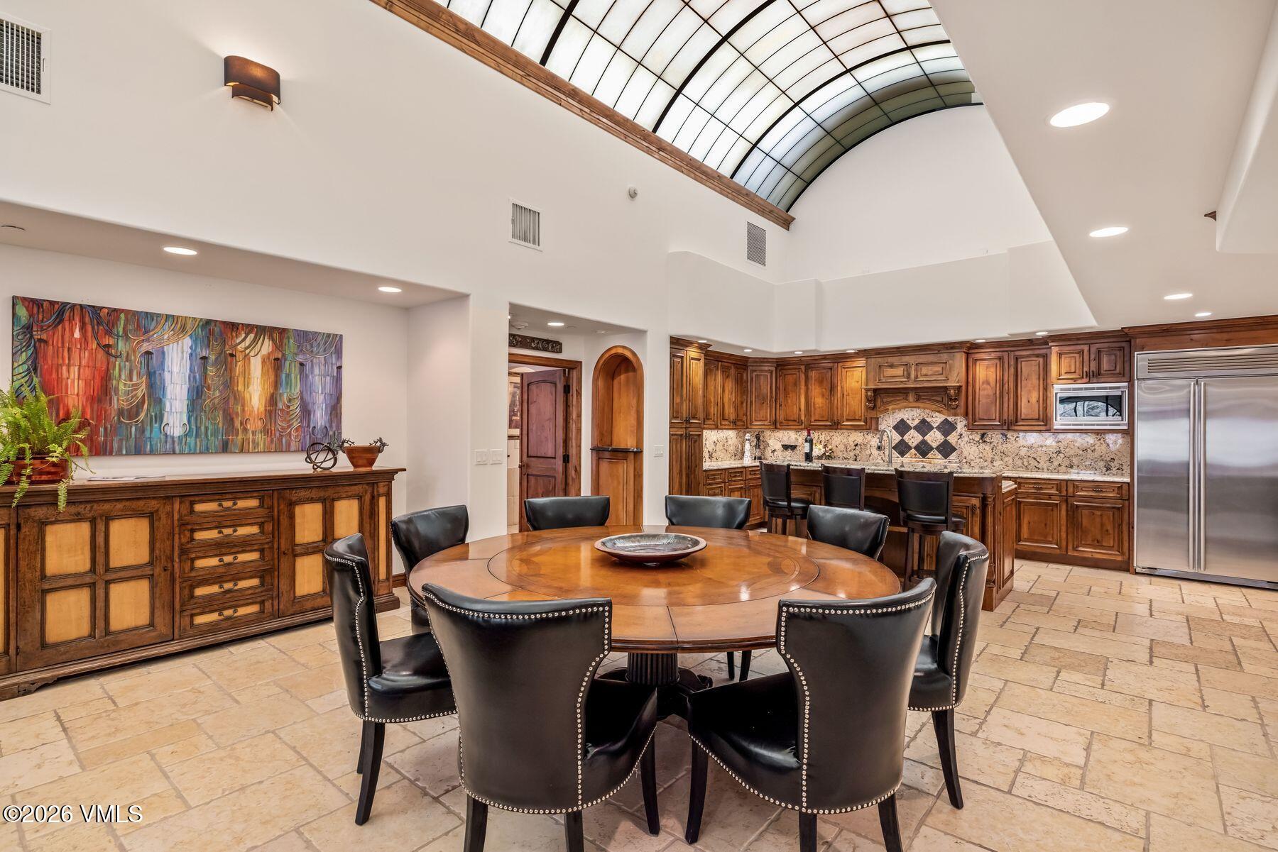 12 Vail Road, Unit R8 Vail, CO 81657 - Photo 17 of 41 a dining room with furniture a window and wooden floor