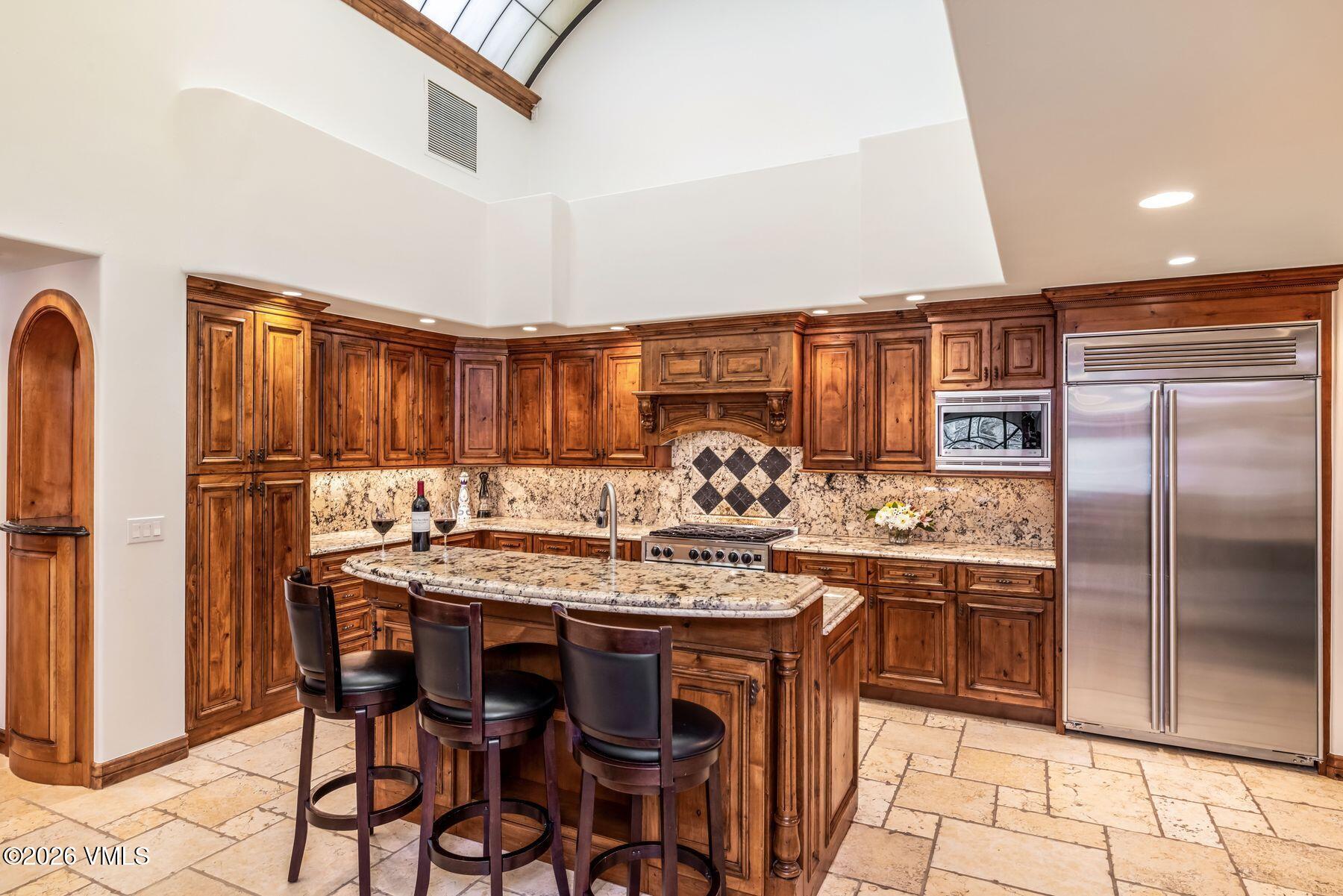12 Vail Road, Unit R8 Vail, CO 81657 - Photo 19 of 41 a kitchen with stainless steel appliances granite countertop a stove a refrigerator and a refrigerator