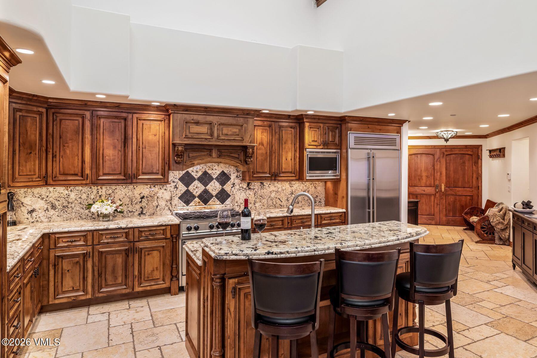 12 Vail Road, Unit R8 Vail, CO 81657 - Photo 20 of 41 a kitchen with a sink and chairs