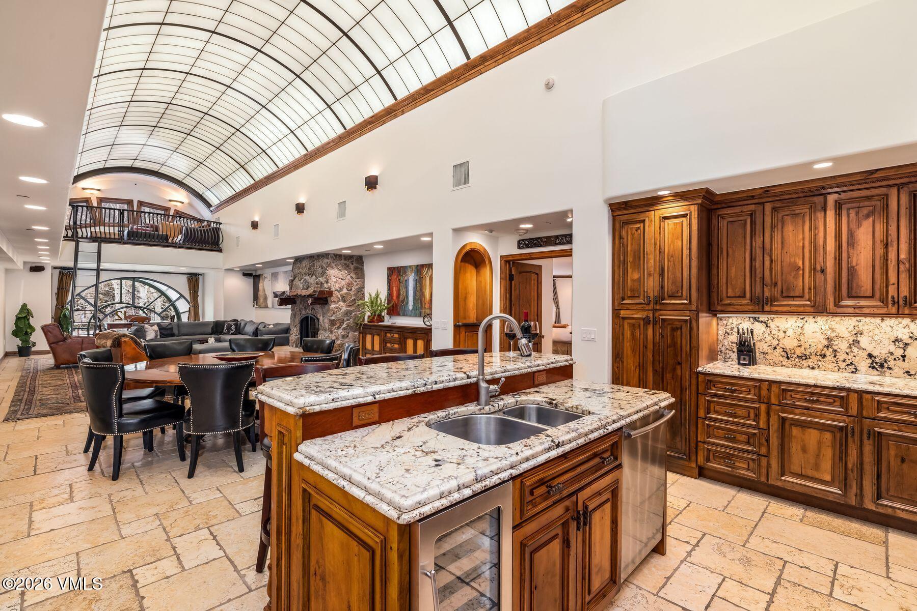 12 Vail Road, Unit R8 Vail, CO 81657 - Photo 21 of 41 a kitchen with stainless steel appliances granite countertop a sink and cabinets