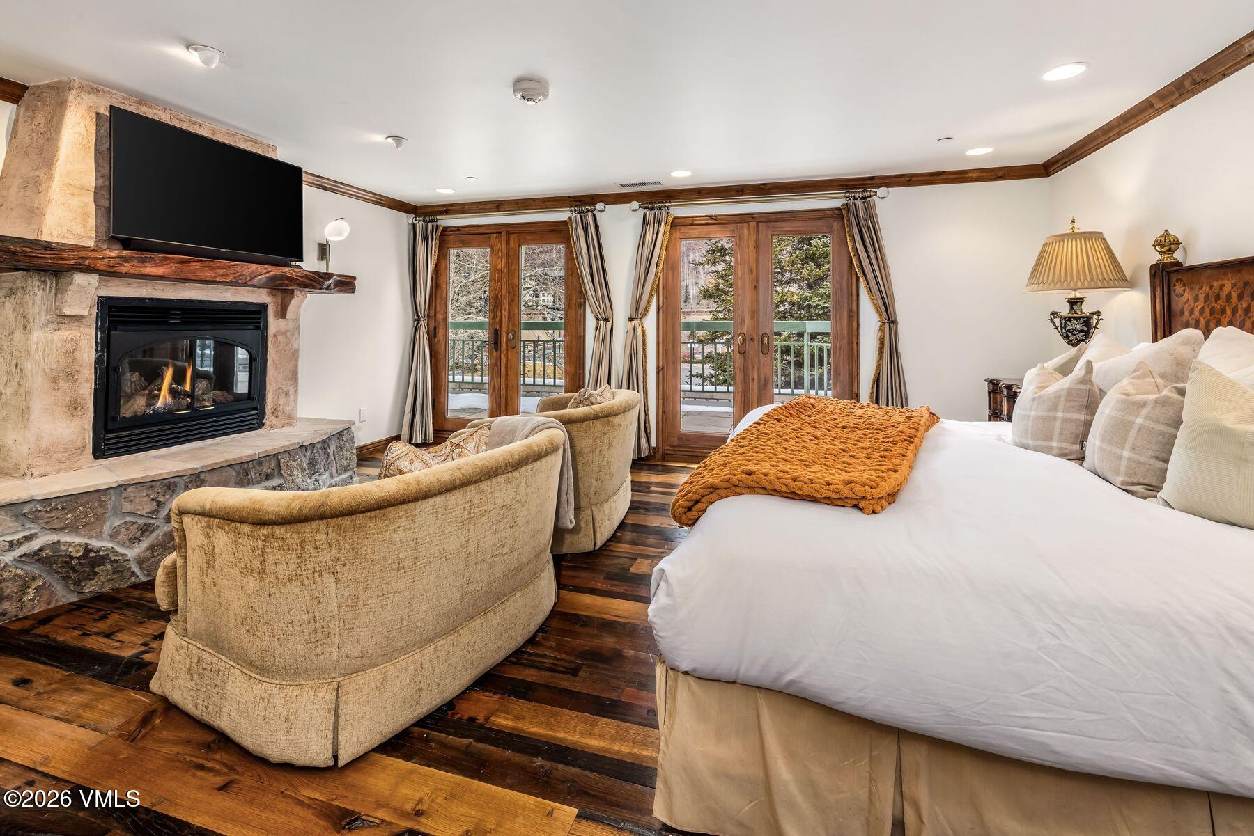 12 Vail Road, Unit R8 Vail, CO 81657 - Photo 24 of 41 a bed room with a bed and a fireplace