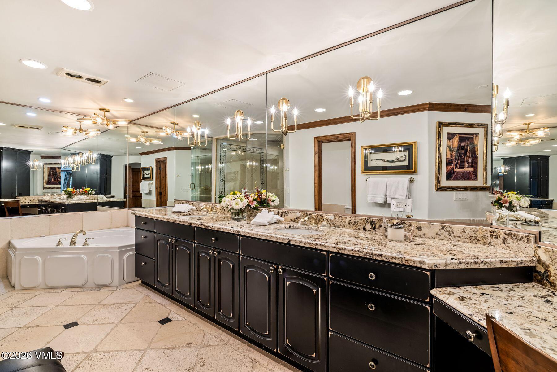 12 Vail Road, Unit R8 Vail, CO 81657 - Photo 28 of 41 a large bathroom with a sink vanity and mirror