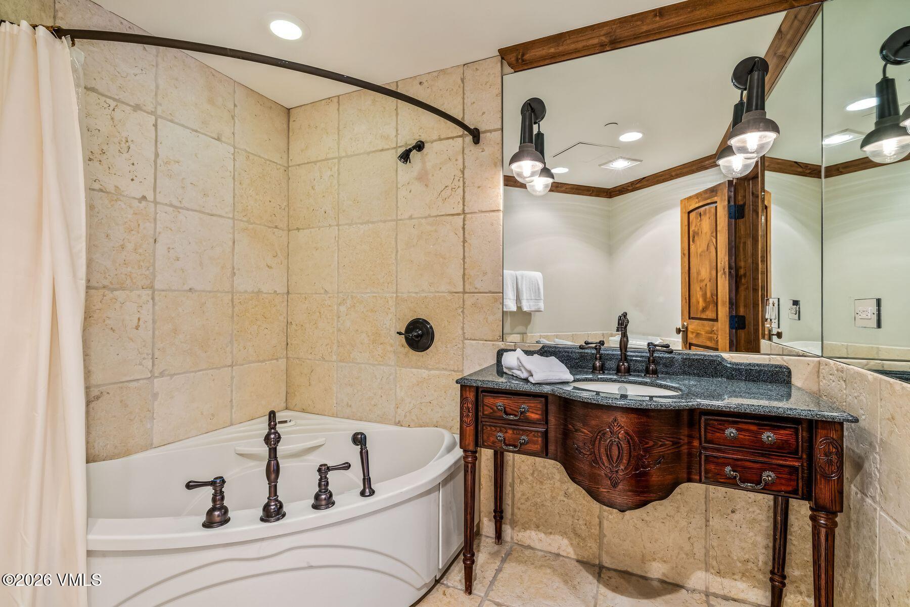 12 Vail Road, Unit R8 Vail, CO 81657 - Photo 35 of 41 a bathroom with a bathtub and a sink