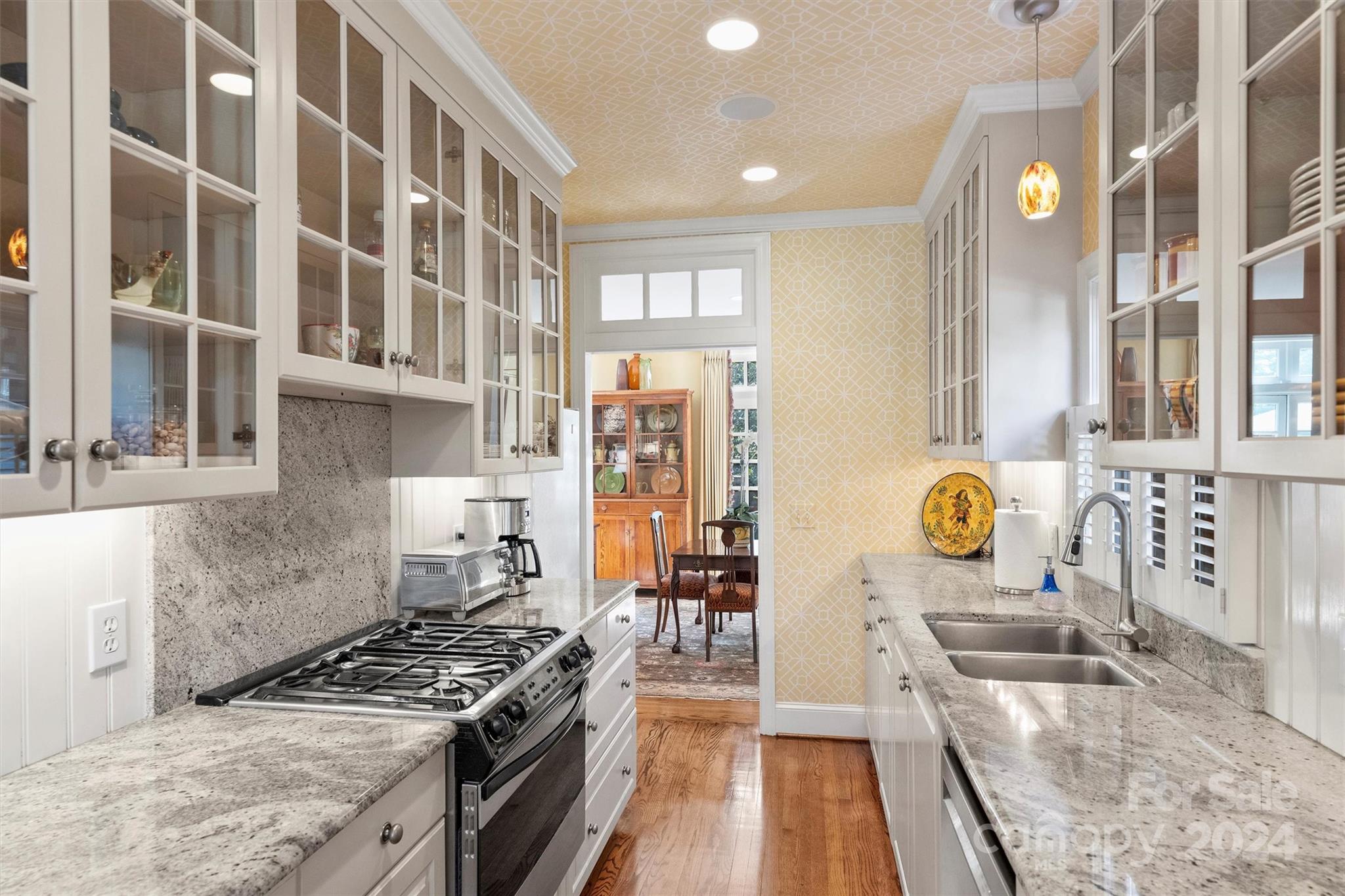 1905 Queens Road Charlotte, NC 28207 - Photo 17 of 44 a kitchen with stainless steel appliances granite countertop a stove and a sink
