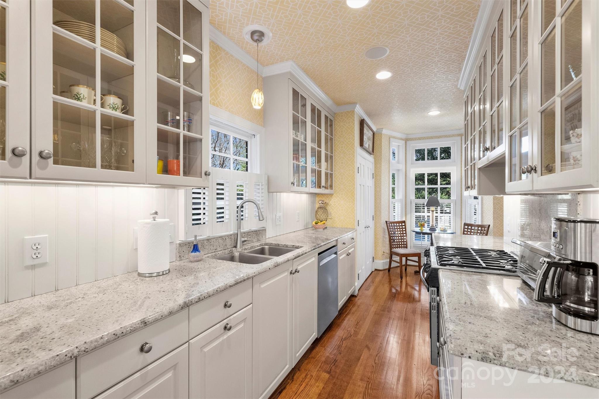 1905 Queens Road Charlotte, NC 28207 - Photo 18 of 44 a kitchen with stainless steel appliances granite countertop a sink stove and cabinets