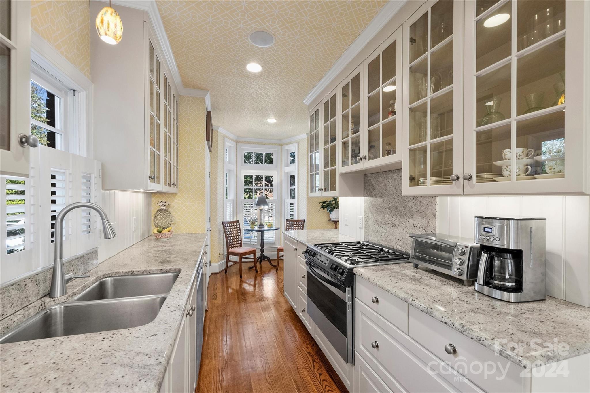 1905 Queens Road Charlotte, NC 28207 - Photo 19 of 44 a kitchen with stainless steel appliances granite countertop a sink stove and cabinets
