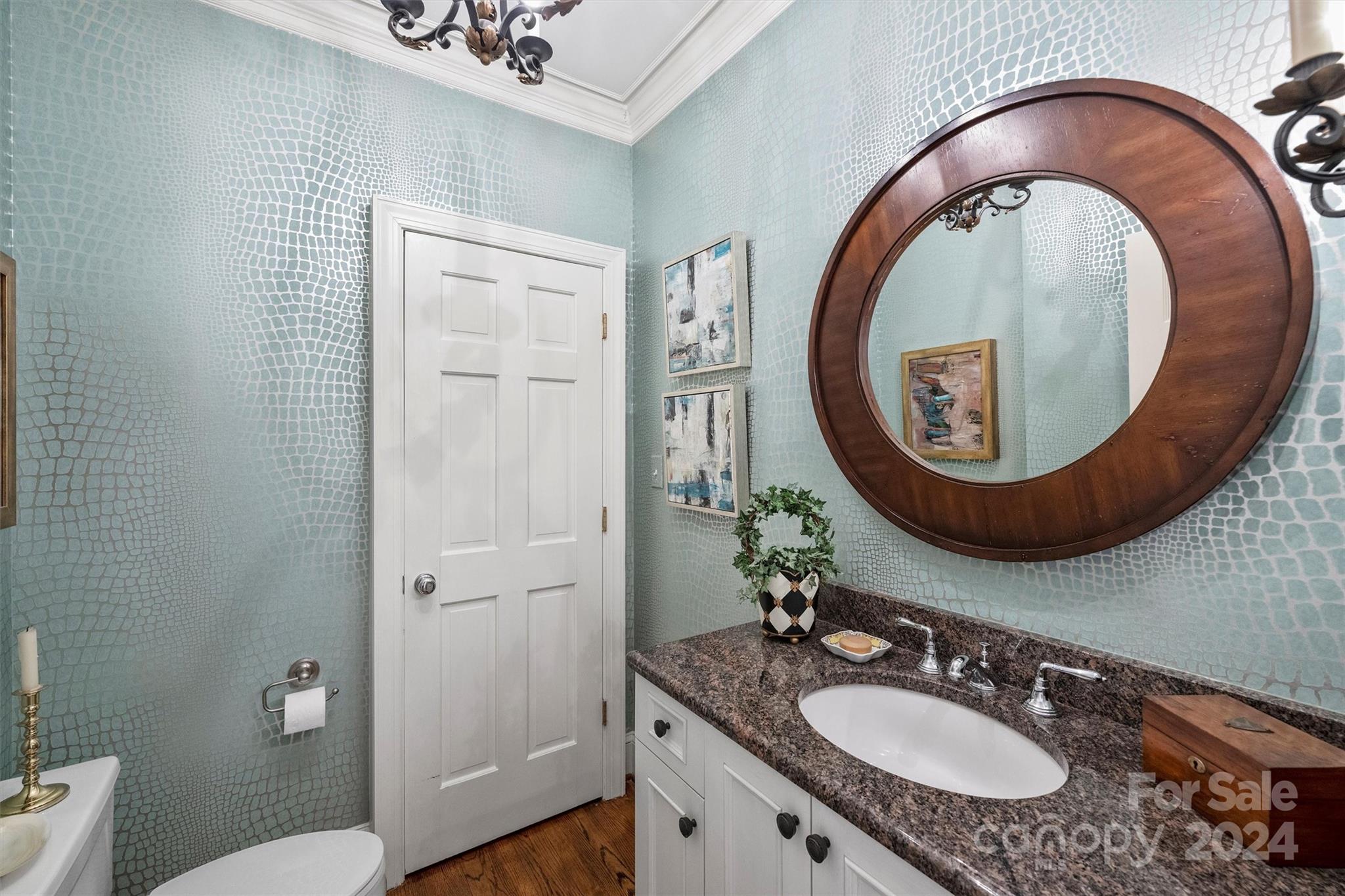 1905 Queens Road Charlotte, NC 28207 - Photo 21 of 44 a bathroom with a granite countertop toilet a sink and a mirror