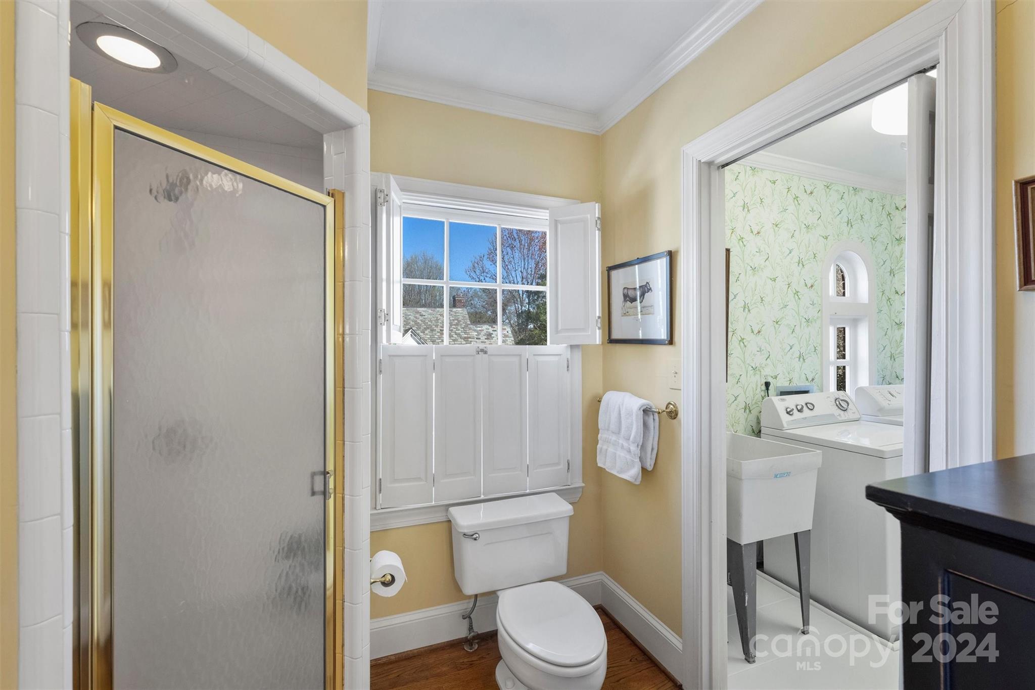 1905 Queens Road Charlotte, NC 28207 - Photo 26 of 44 a white toilet sitting next to a bathroom sink