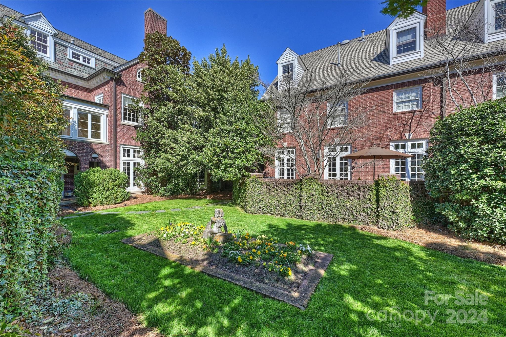 1905 Queens Road Charlotte, NC 28207 - Photo 39 of 44 a view of a brick building next to a yard