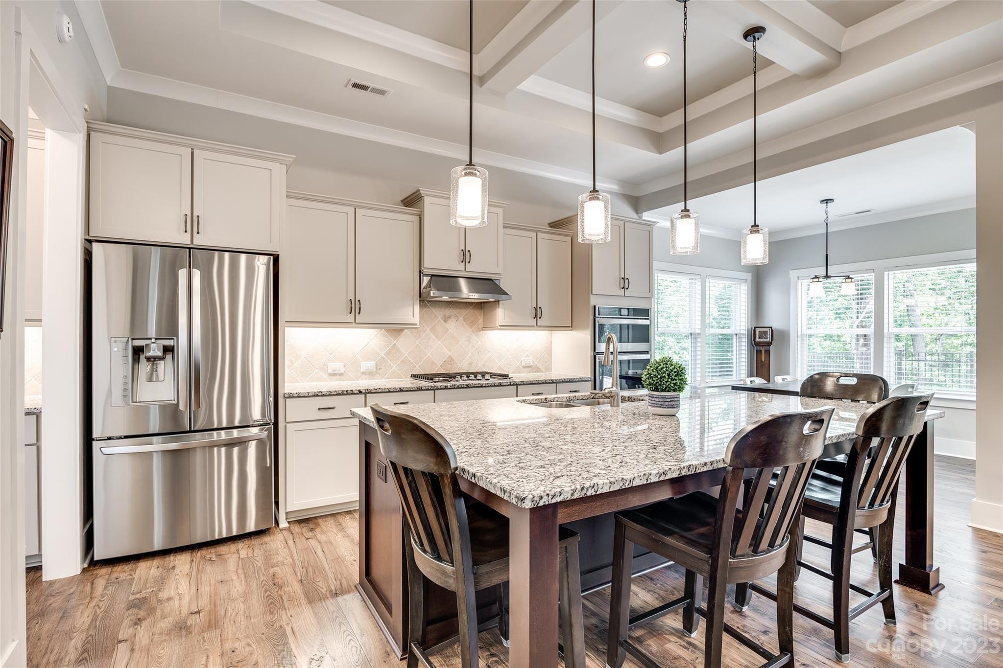 5284 Admirals Landing Lancaster, SC 29720 - Photo 12 of 48 a kitchen with granite countertop a table chairs stainless steel appliances and wooden floor