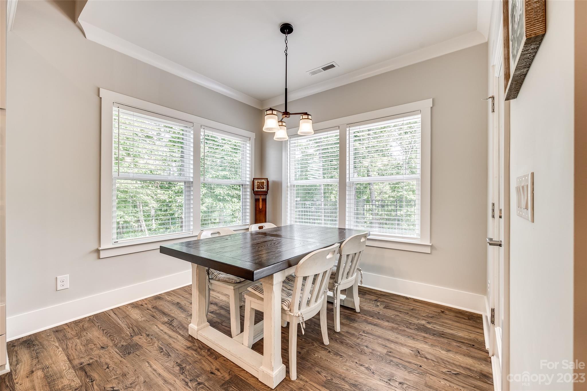 5284 Admirals Landing Lancaster, SC 29720 - Photo 16 of 48 a dining room with wooden floor a chandelier a wooden table and chairs