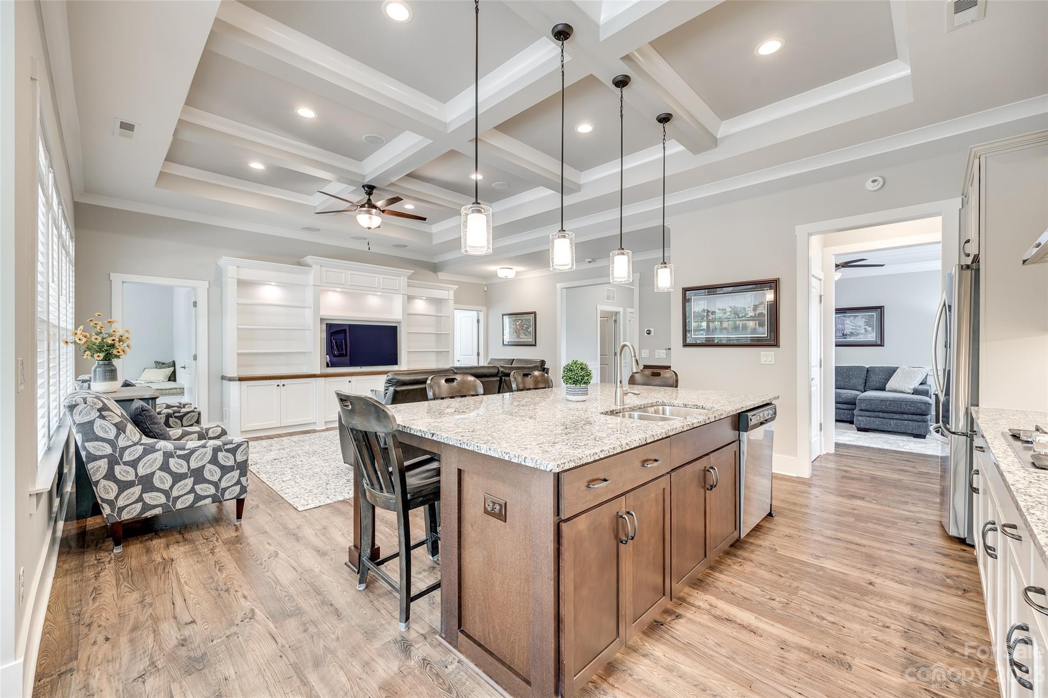 5284 Admirals Landing Lancaster, SC 29720 - Photo 9 of 48 a large kitchen with kitchen island a stove a sink dishwasher and a dining table with wooden floor