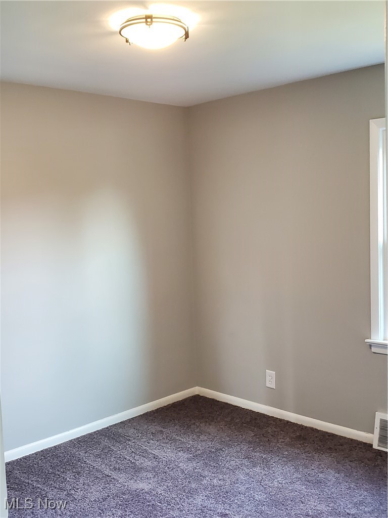 7007 Biddulph Road Brooklyn, OH 44144 - Photo 8 of 16 Spare room featuring dark colored carpet and baseboards