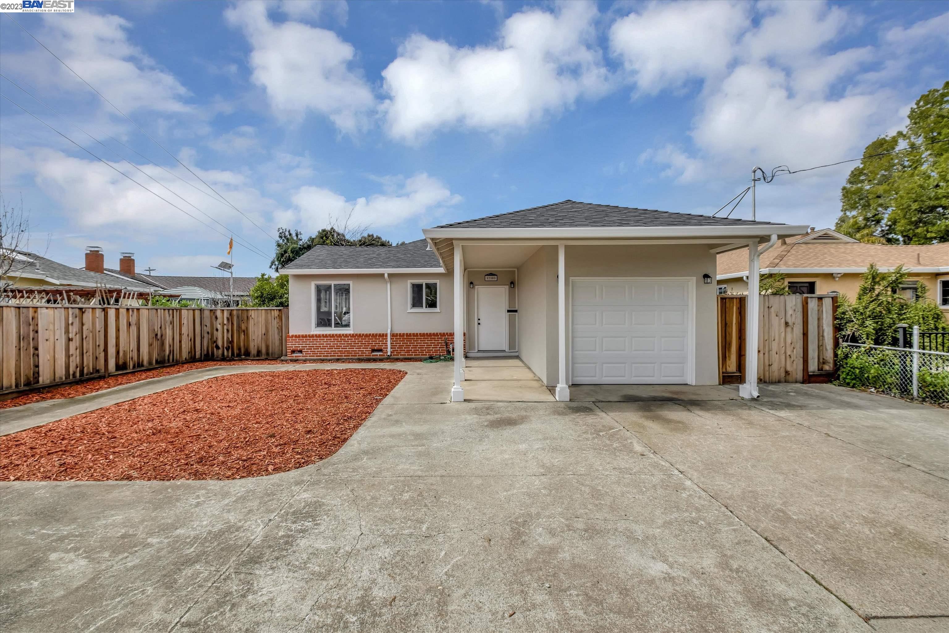 a view of a house with wooden fence