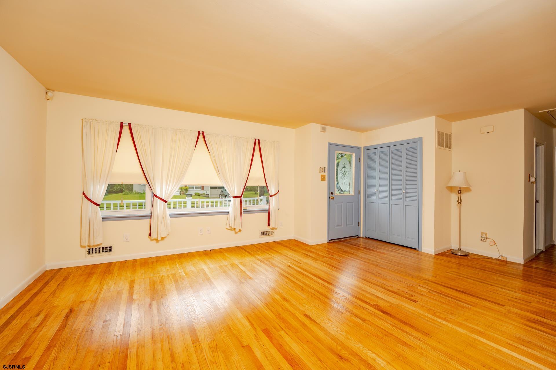 153 Jordan Road Somers Point, NJ 08244 - Photo 11 of 37 a view of an empty room with wooden floor and a window