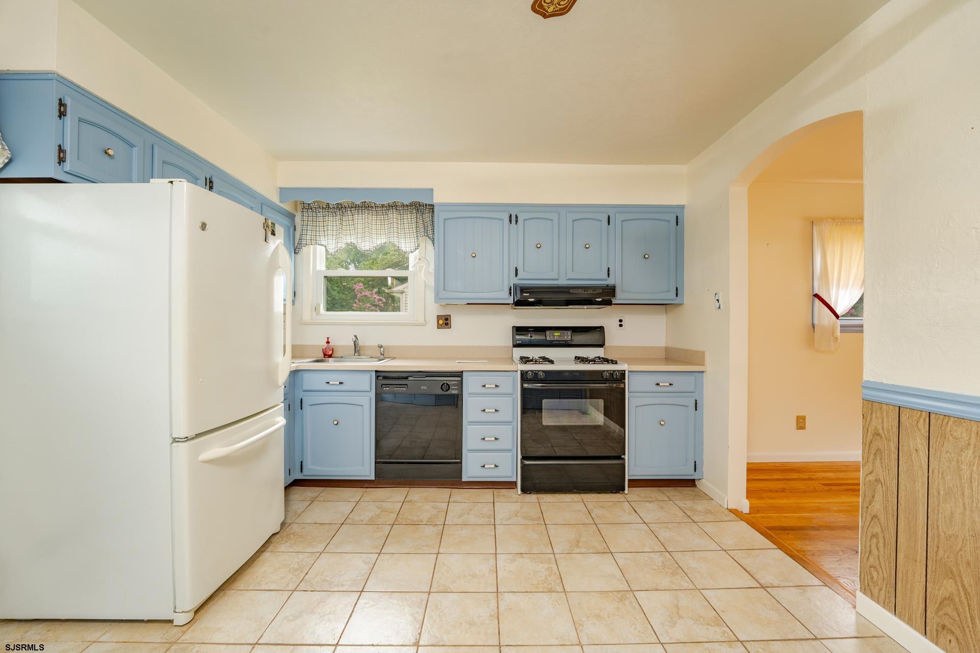 153 Jordan Road Somers Point, NJ 08244 - Photo 13 of 37 a kitchen with a refrigerator a stove top oven and cabinets