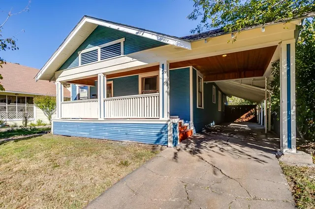 a front view of a house with a yard outdoor seating and barbeque oven