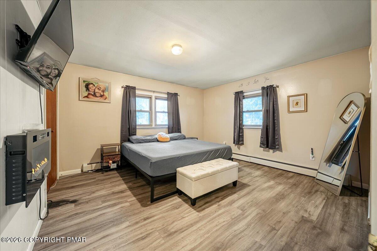 159 Summit Avenue Pocono Summit, PA 18346 - Photo 14 of 21 a spacious bedroom with a bed and a flat screen tv