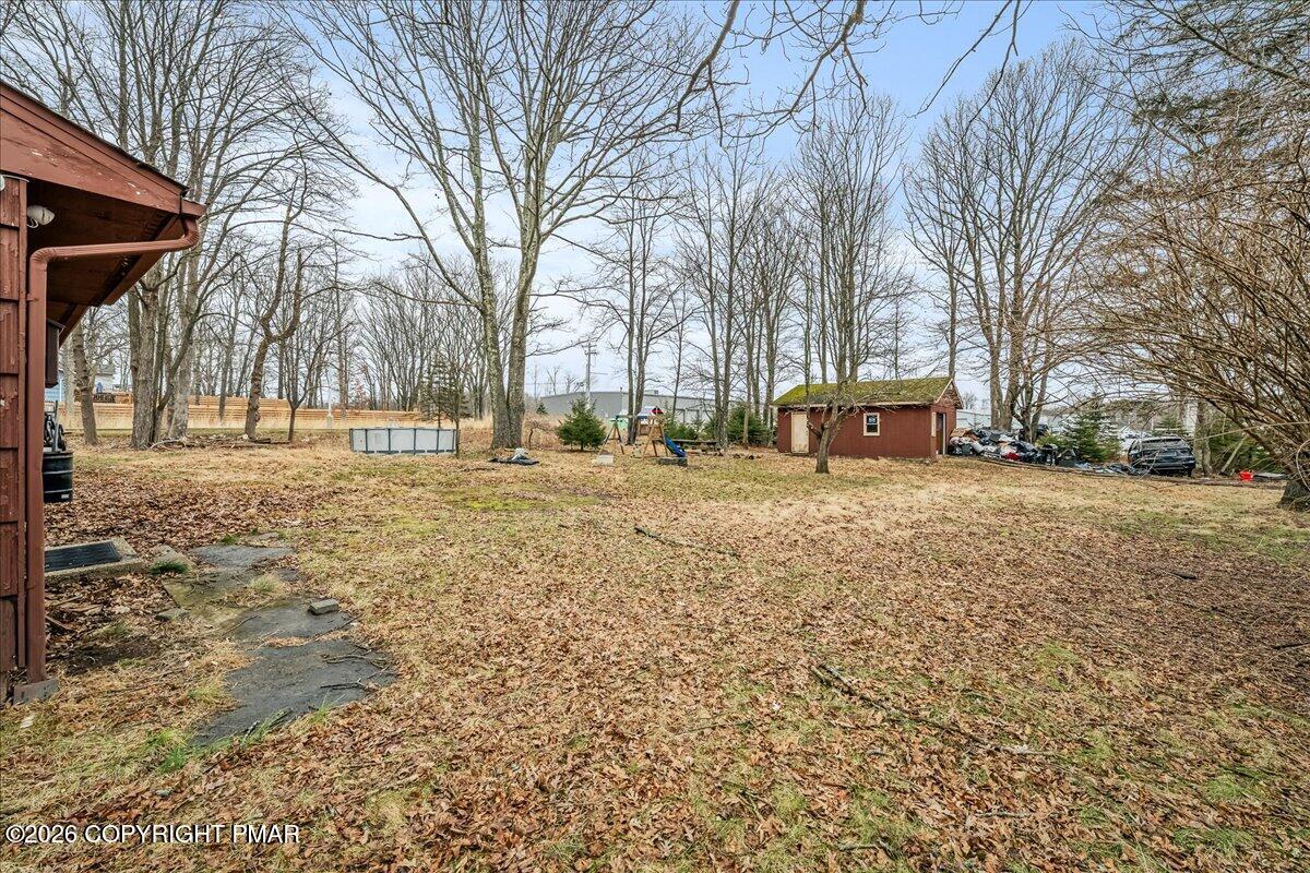 159 Summit Avenue Pocono Summit, PA 18346 - Photo 2 of 21 a view of road with trees