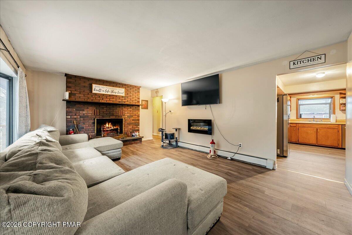 159 Summit Avenue Pocono Summit, PA 18346 - Photo 3 of 21 a living room with furniture a flat screen tv and a fireplace
