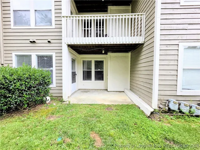a view of a house with a yard and porch