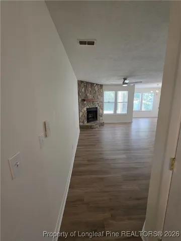 a view of a hallway with a fireplace