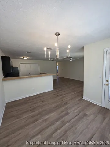 a view of a big room with wooden floor and an cabinet