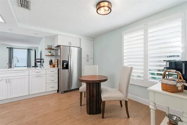 a room with a chair and a refrigerator