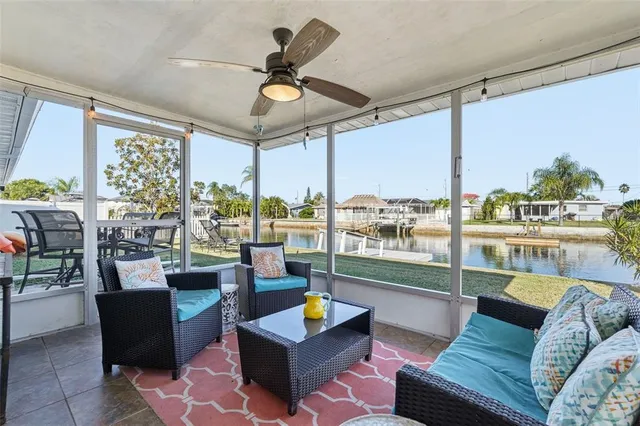 a living room with furniture and a floor to ceiling window