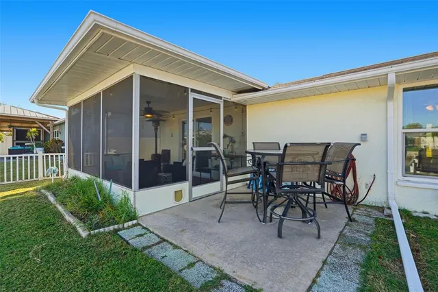 a view of a house with backyard and porch