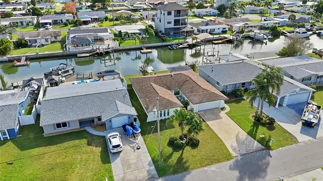an aerial view of a house with a swimming pool yard and outdoor seating