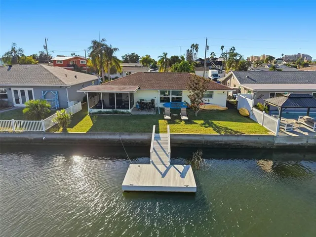 a view of a house with pool and chairs