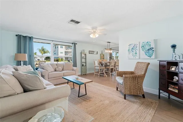 a living room with furniture and a painting on the wall