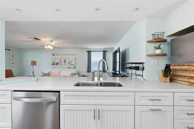a kitchen with cabinets appliances and a counter space