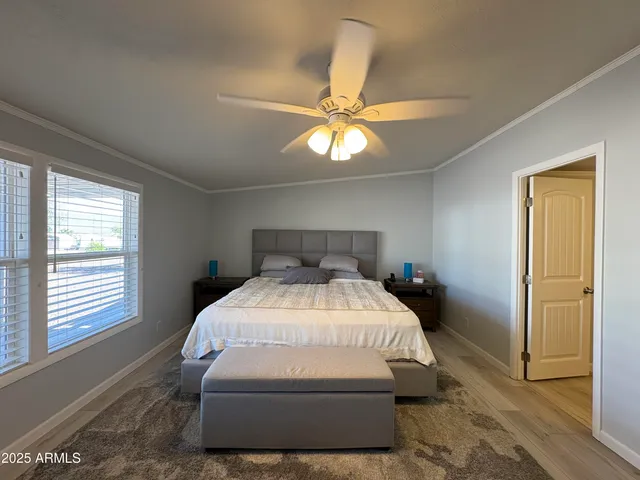 a bedroom with a bed and a chandelier