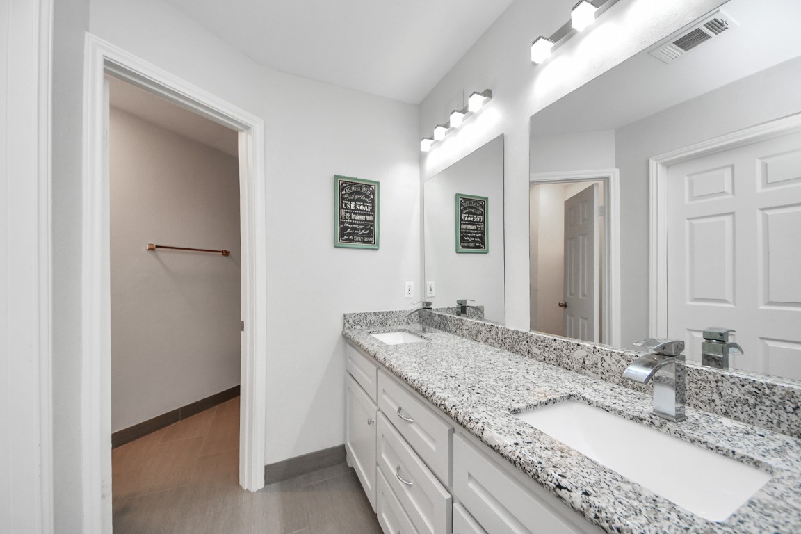 2468 Bering Drive Houston, TX 77057 - Photo 18 of 30 Dual vanities and modern finishes create a relaxing and functional space.
