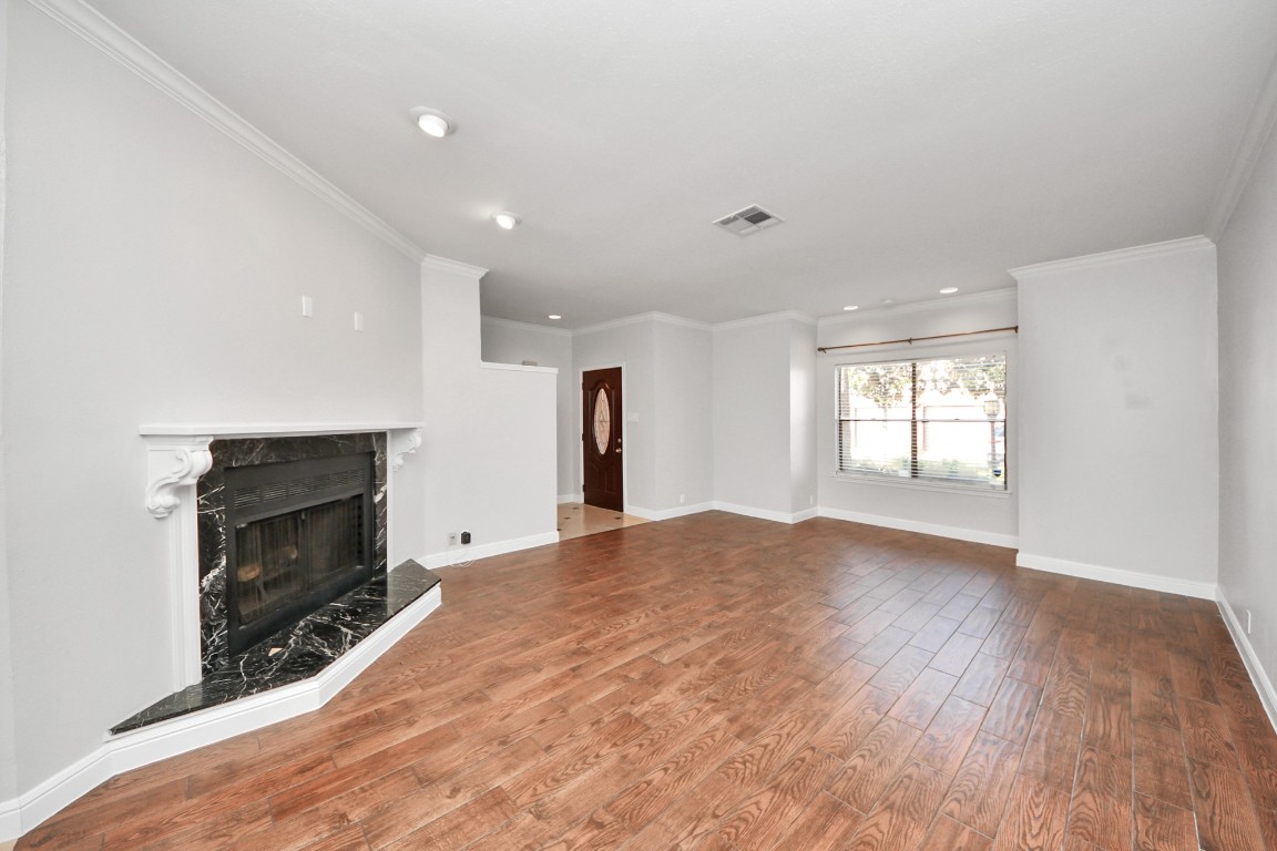 2468 Bering Drive Houston, TX 77057 - Photo 6 of 30 A spacious living area provides the perfect setting for relaxing or entertaining guests. Natural light and an inviting fireplace create a warm and welcoming atmosphere.