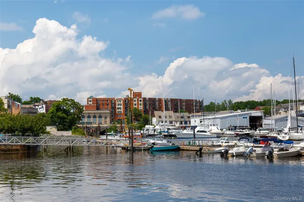 a view of water with boats and trees in the background