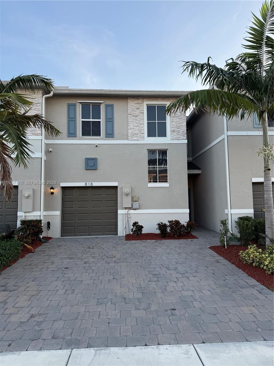 818 South E 19th Street, Unit 818 Homestead, FL 33034 - Photo 3 of 10 a front view of a house with a yard