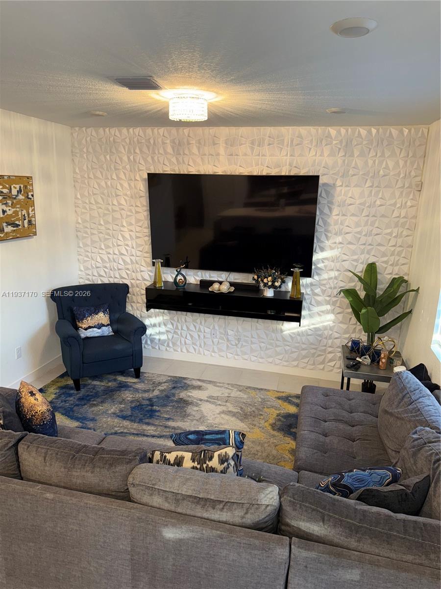 818 South E 19th Street, Unit 818 Homestead, FL 33034 - Photo 6 of 10 a living room with furniture and a flat screen tv