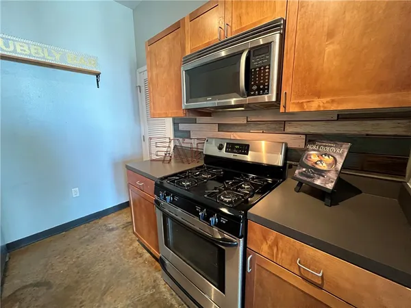 a kitchen with a stove and a microwave
