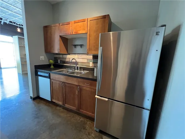 a kitchen with stainless steel appliances a refrigerator and a sink