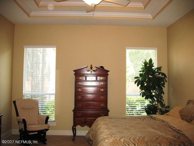 376 North Lombardy Loop Jacksonville, FL 32259 - Photo 15 of 24 a bedroom with a bed and a chair with the potted plant