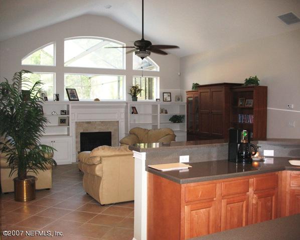 376 North Lombardy Loop Jacksonville, FL 32259 - Photo 5 of 24 a kitchen with furniture a large window and a fireplace
