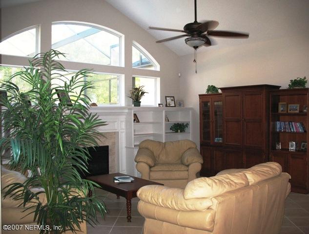 376 North Lombardy Loop Jacksonville, FL 32259 - Photo 7 of 24 a living room with furniture a window and a fireplace