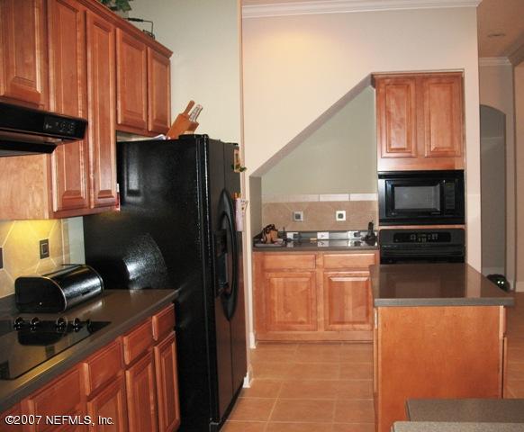 376 North Lombardy Loop Jacksonville, FL 32259 - Photo 9 of 24 a kitchen with stainless steel appliances granite countertop a refrigerator and a stove top oven